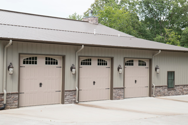 Three garage doors along a clear pavement path, perfect for plenty vehicles inside.  