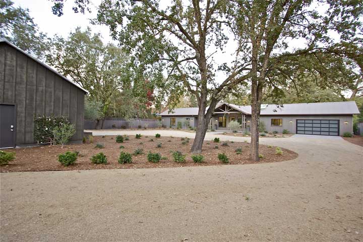 The Ranch home sits comfortably on the property, surrounded by trees and shrubs.