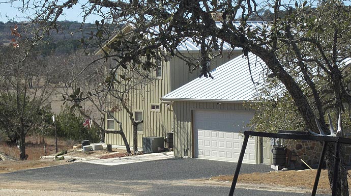 The entrance to the garage at the rear side of the ranch home.