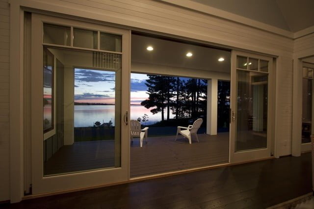 The glass doors leading to the rear porch, with a spacious area and elegant setup, offered a stunning view of the surrounding landscape.