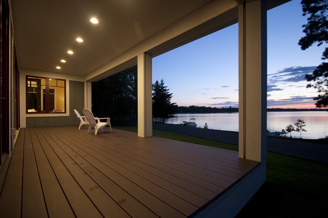 The rear porch of the lakeside cabin was the perfect spot to watch the sunset, with comfortable chairs arranged to face the sky over the waters of the lake.