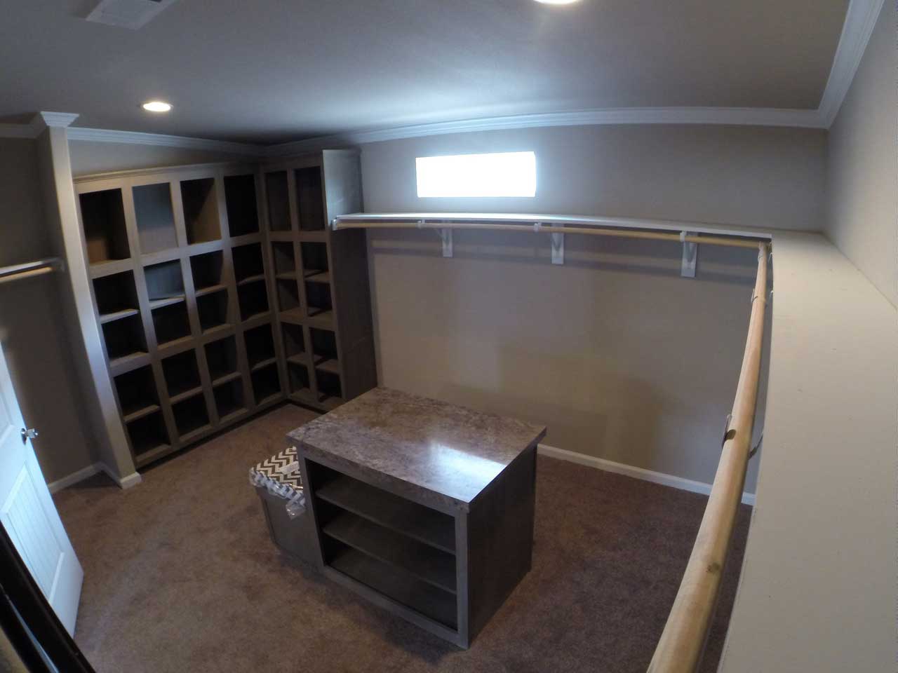 A spacious walk-in closet with ample shelving and a cabinet for organizing and storing personal belongings.