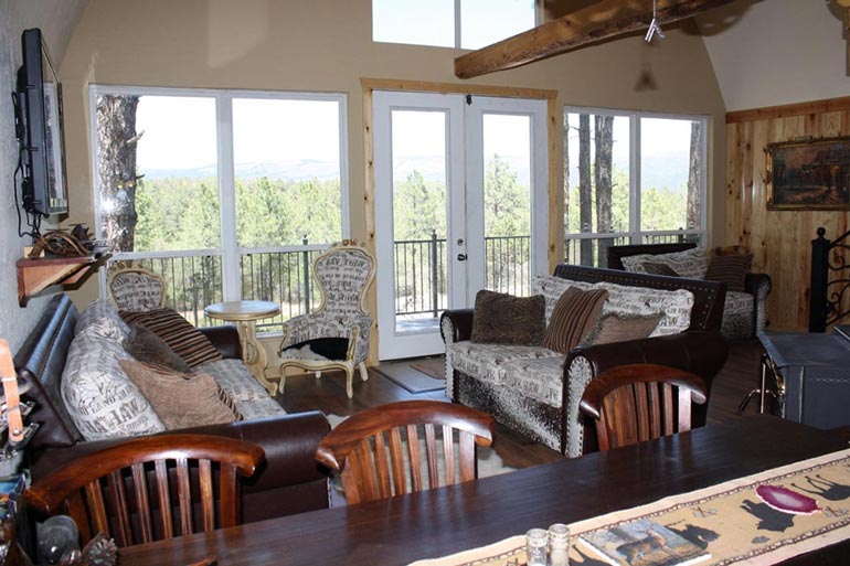 The Living room of the Arched Metal Cabin interior is given a picturesque view, perfect for relaxation.