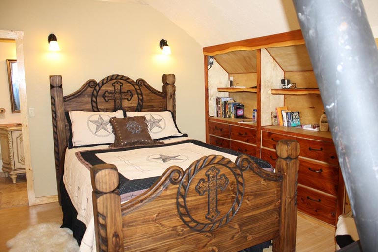 The bedroom of the Arched Metal Cabin exudes a vintage feel.