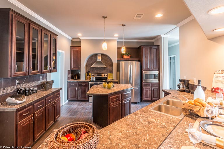 The kitchen boasts sleek wooden cabinetry and a large island in the middle, providing ample storage and workspace.