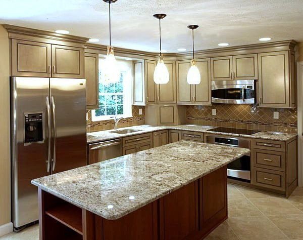 Kitchen equipped with an island counter, steel appliances, and wooden cabinetry.