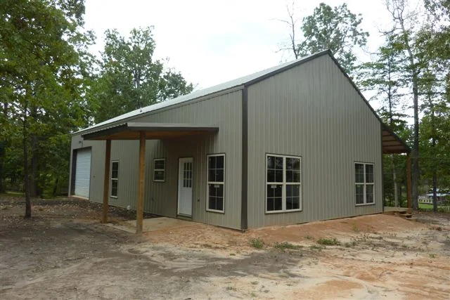 The exteriors of the pole barn home in grey.