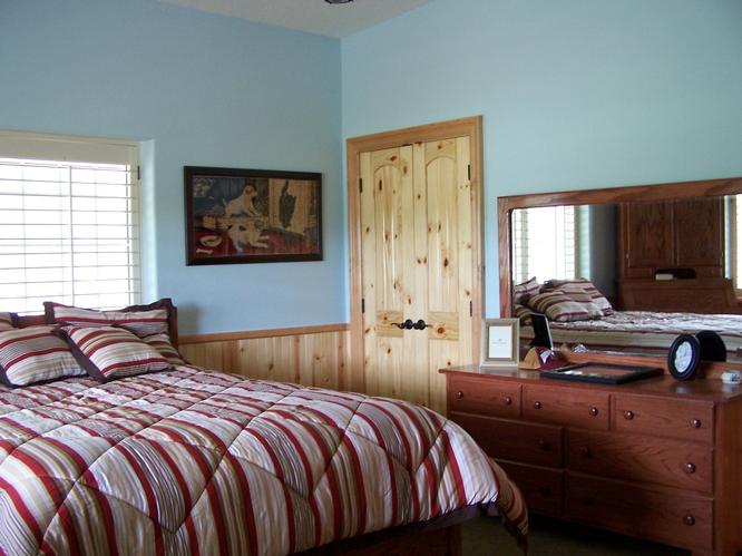 the Bedroom features a bed and dresser with a mirror.