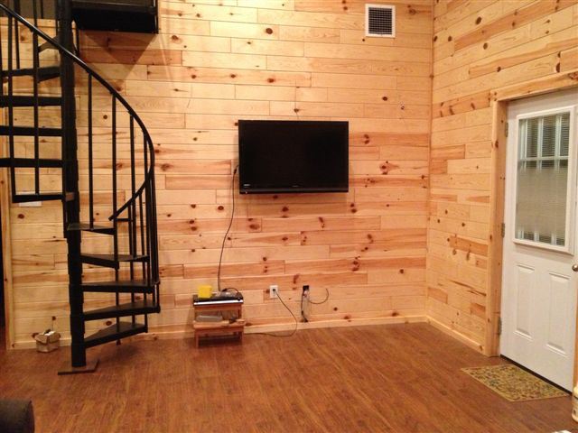 Wall mounted TV in the pole barn home living room.