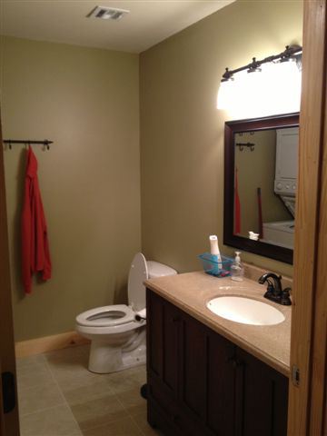 Bathroom, equipped with vanity sink and toilet.