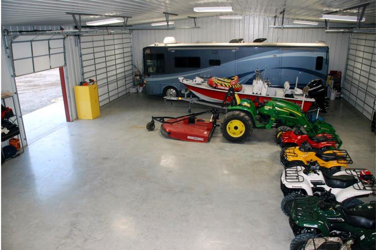 The garage with garage doors on both sides. The large size and double doors allow for easy access and ample room for storing and organizing vehicles or other items.
