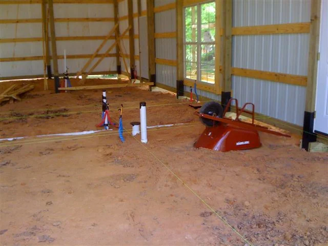 Construction of the concrete flooring of the pole barn home.