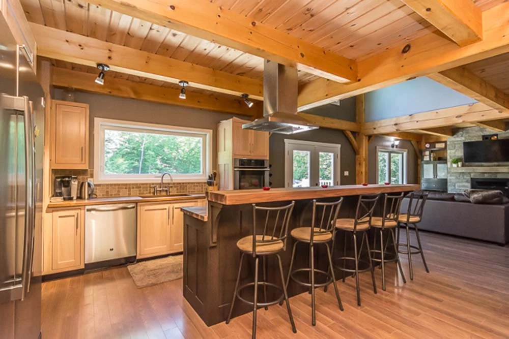 The kitchen boasts a spacious workspace, includes an island bar with five stools.