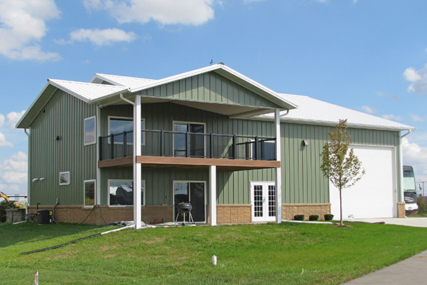 A metal building home from lester buildings with a gabled roof in an olive color scheme