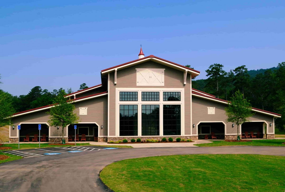 Metal building with tall front windows in sand color exterior erected by Metallic Building Company