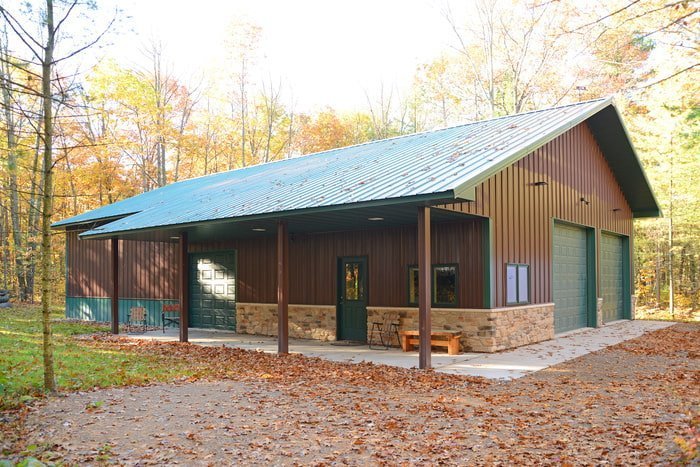 Post-frame brown toy shed with green roof and metal siding erected by Wick Buildings