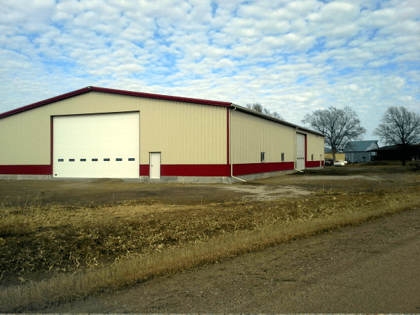 One story Duro steel building with sandy color exterior and red trim