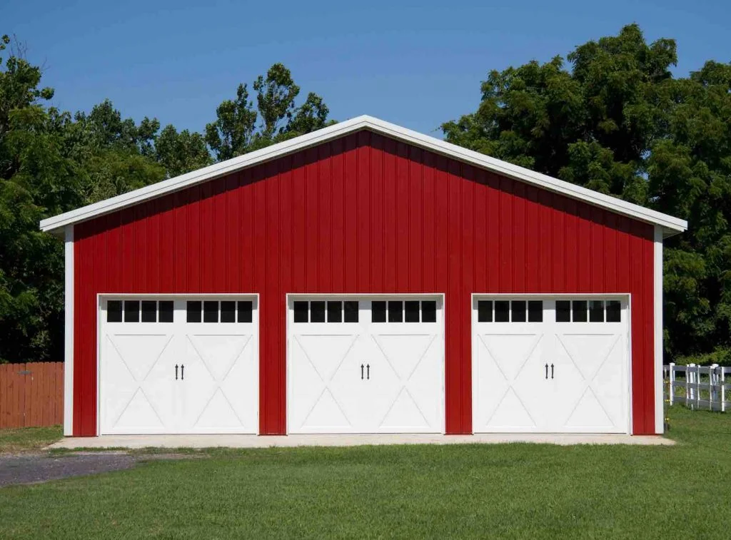 Red three-door pole barn garage by APB Pole Barns.