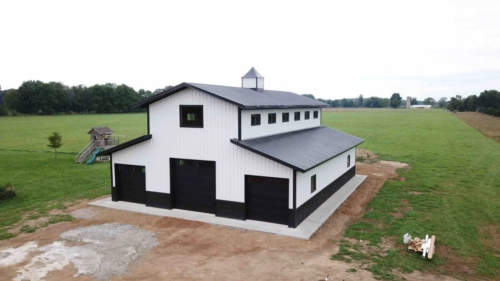 White and grey monitor style amish pole barn raised by Milmar Pole Buildings company.