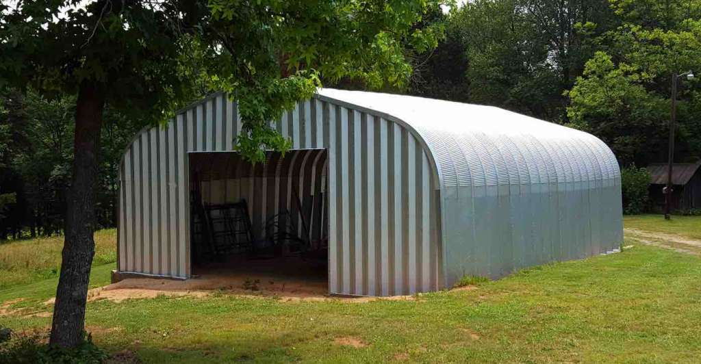 20' x 40' Galvalume Steel Garage sitting on the grass surrounded by trees manufactured by Steel Factory Mgf.