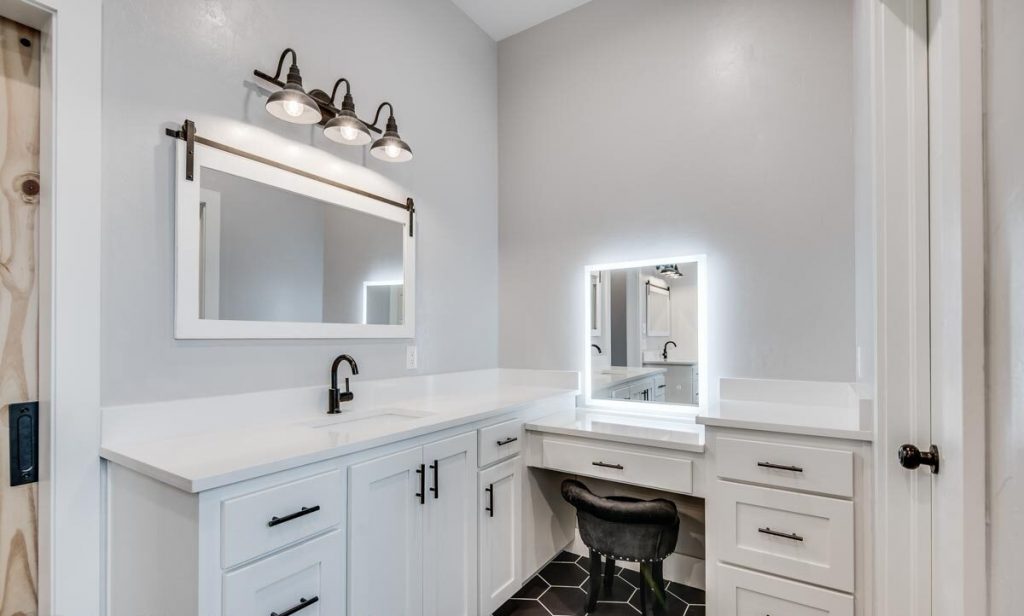 Bathroom with a countertop and sink as well as a mounted wall mirror.