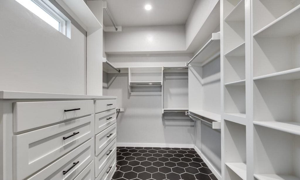 Master closet with wide racks and drawers for easy storage.