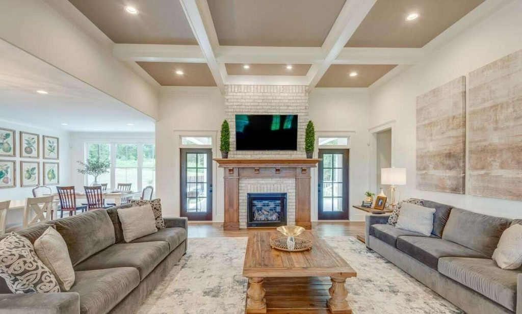 Great Room showcasing the fireplace, a mounted TV, coffee table, and sofa
