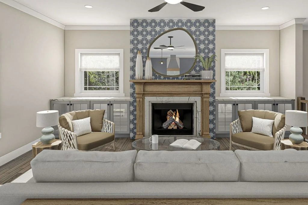 The great room shows a fireplace, comfy grey sofa, armchairs, small tables, and cabinets