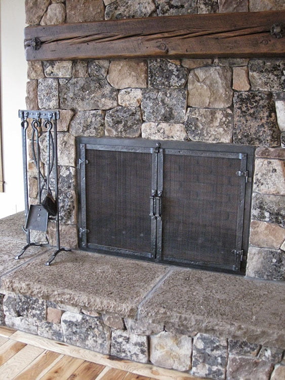 The living room's natural stone fireplace.