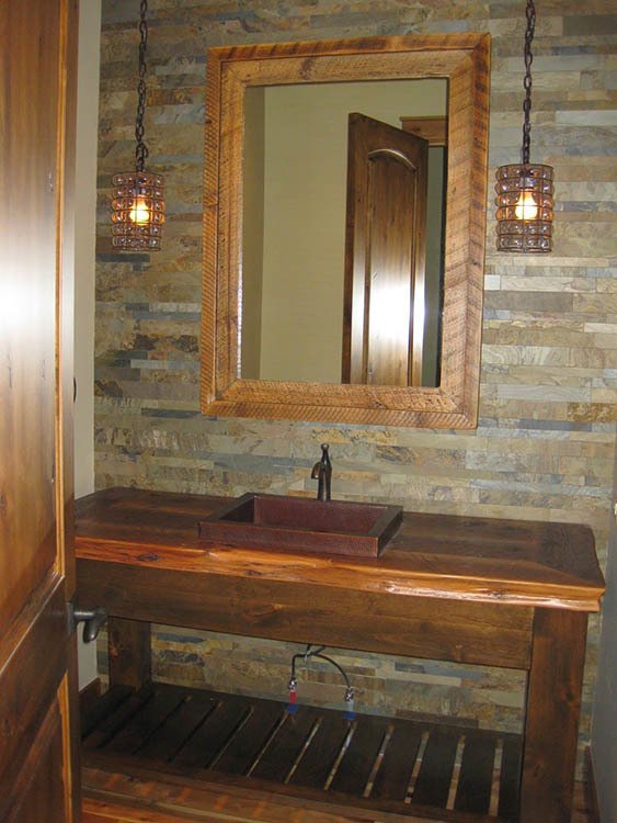 The bathroom, showcasing a wooden vanity with a sink, and antique-style glass lighting.