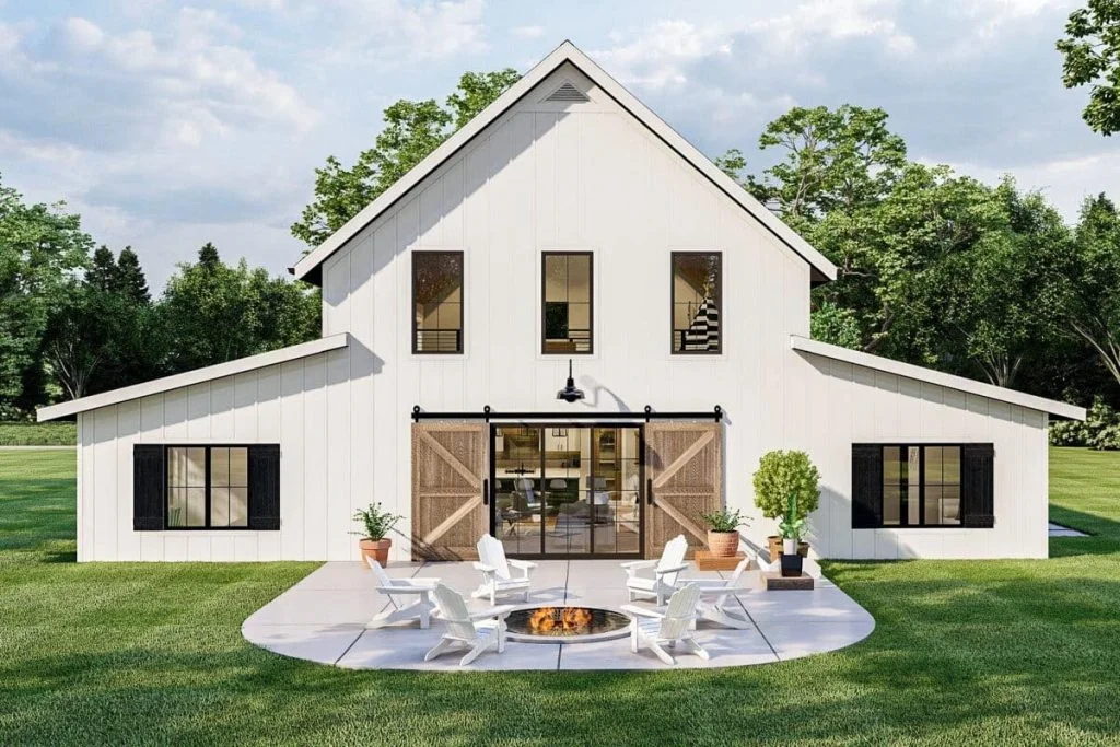 Rear view of the Modern Farmhouse showcasing an open back patio, loft wood slide door, spaced windows on the 2nd floor, and home office and bedroom windows on the side