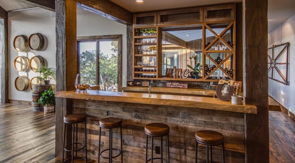The kitchen bar with a wooden countertop and wooden stools