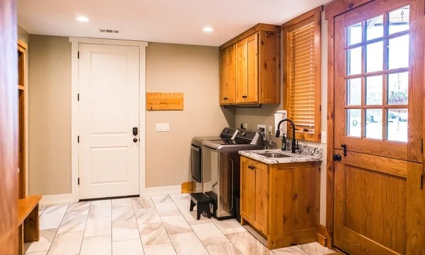 Utility room with laundry appliances and cabinetry.