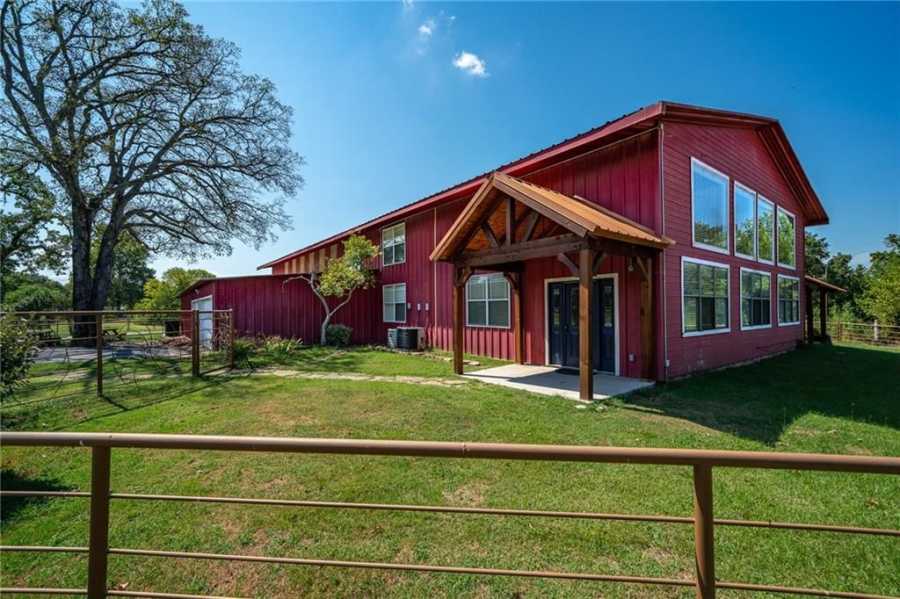 Huge red barndominium with garage and stable includes 5 bedrooms and 4 bathrooms
