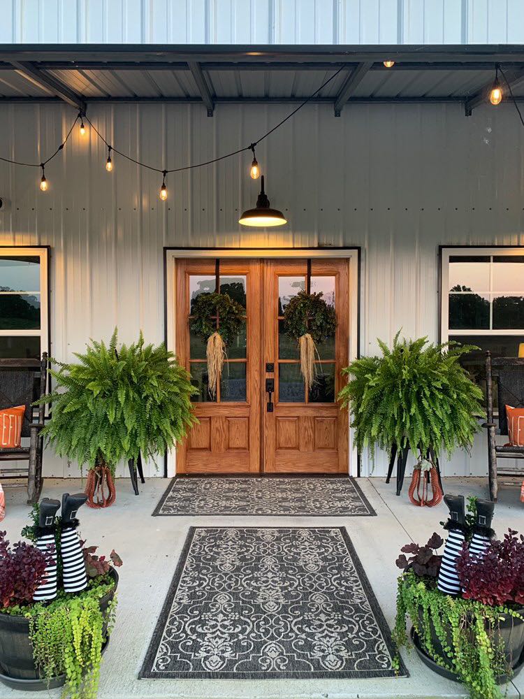 rear entrance adorned with beautiful plants and patterned rugs