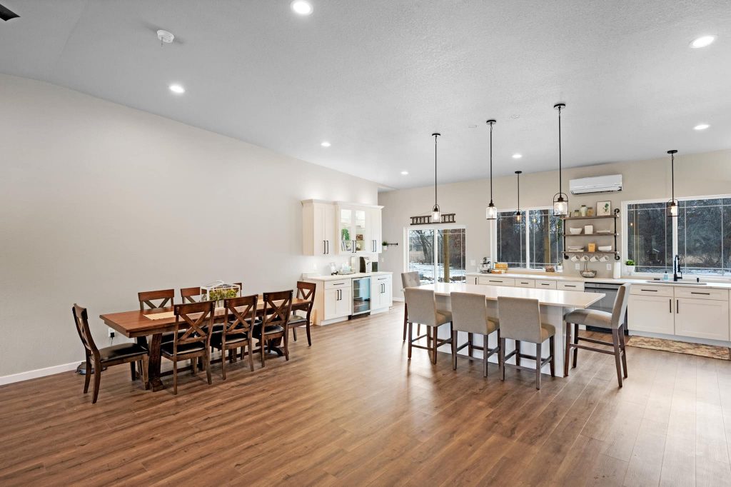 spacious diningroom with two sets of dining tables and chairs