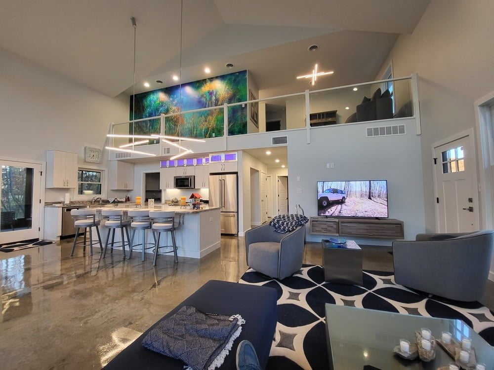 Interior of Charlie's Barndominium. The loft area is visible, with a spacious living space