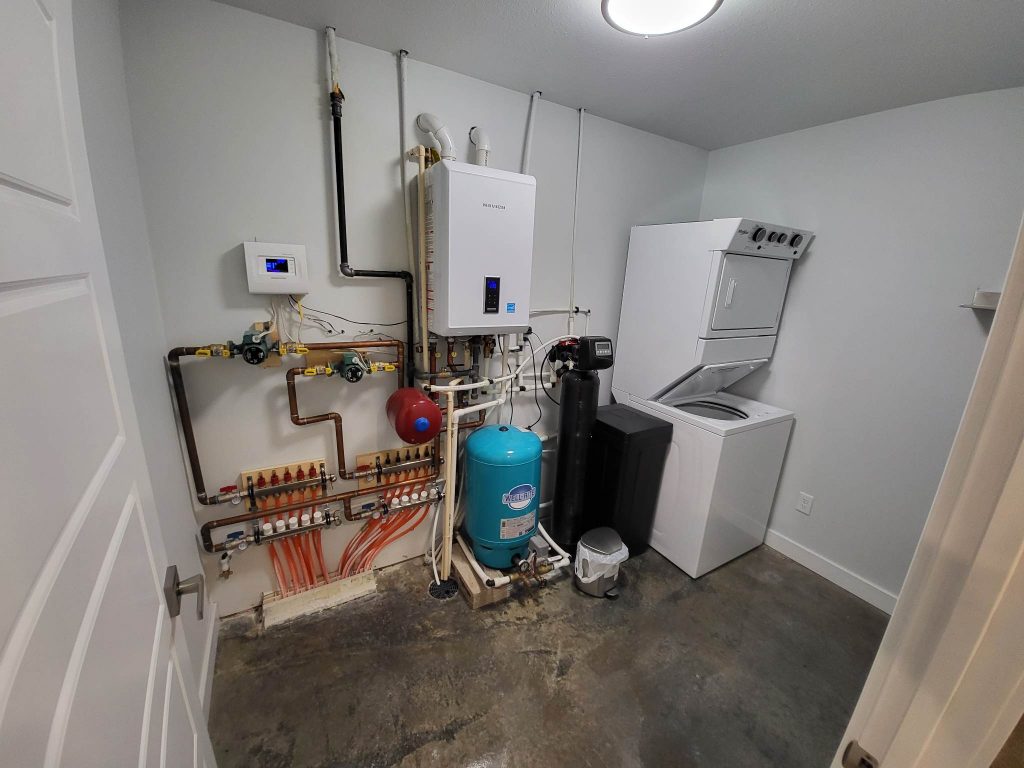 Laundry room with electrical and water heater systems