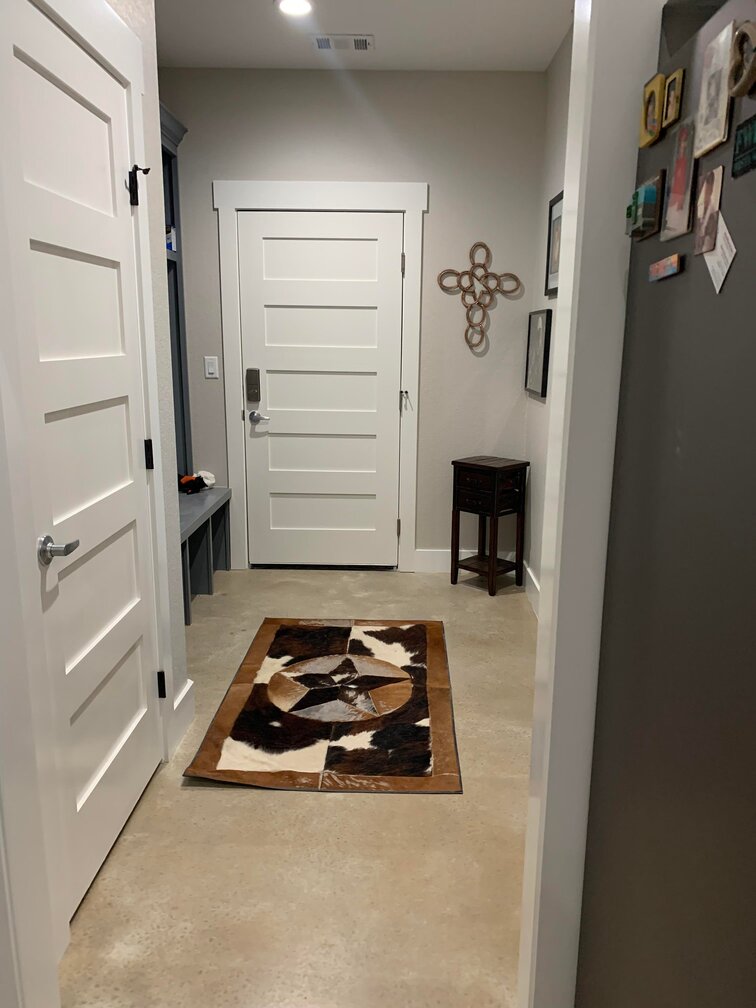 Hallway with white doors and a star patterned rug