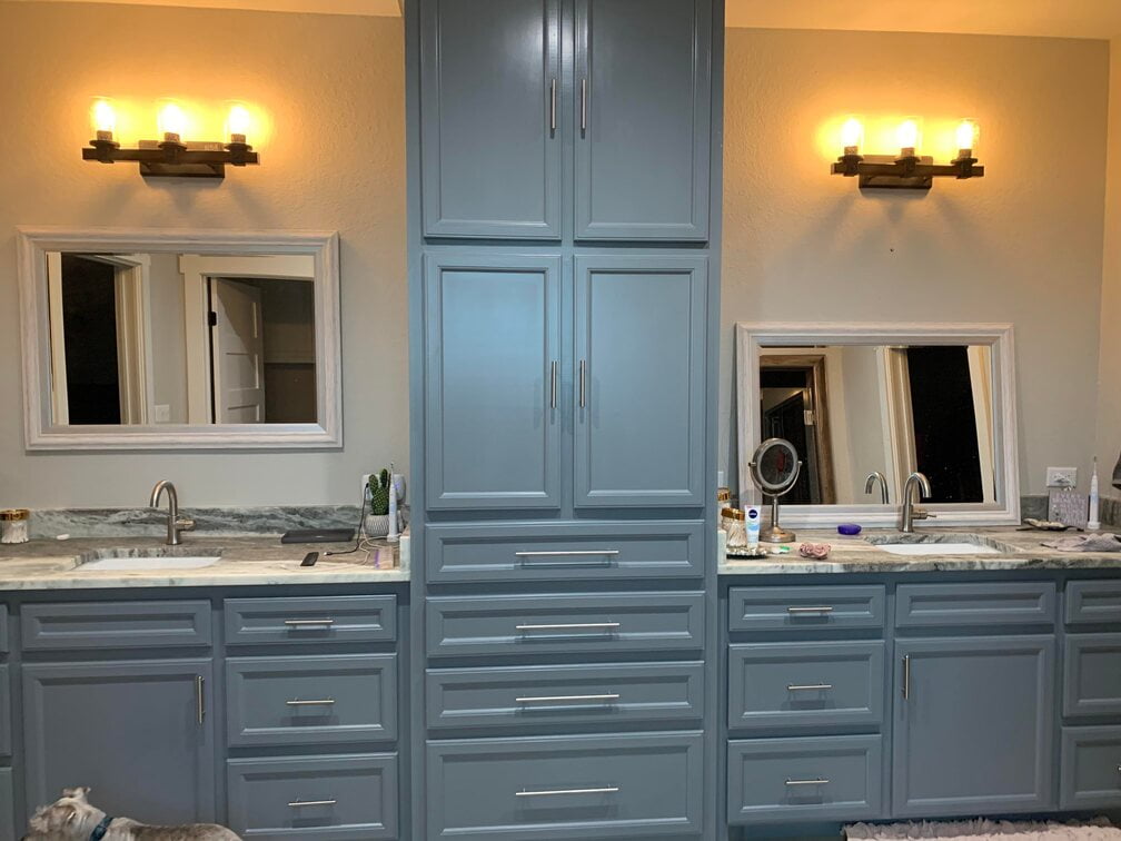Bathroom with a stack of drawers and mirrors on both sides