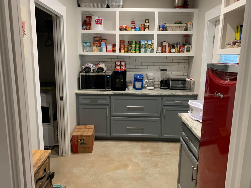 Kitchen and pantry with shelved food and drawers