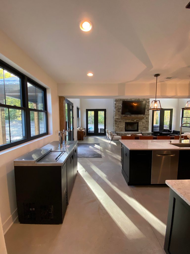 The view of the kitchen leading to the back glass doors.