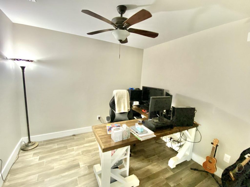 Brandon's office, with an L-shaped desk and computer set.