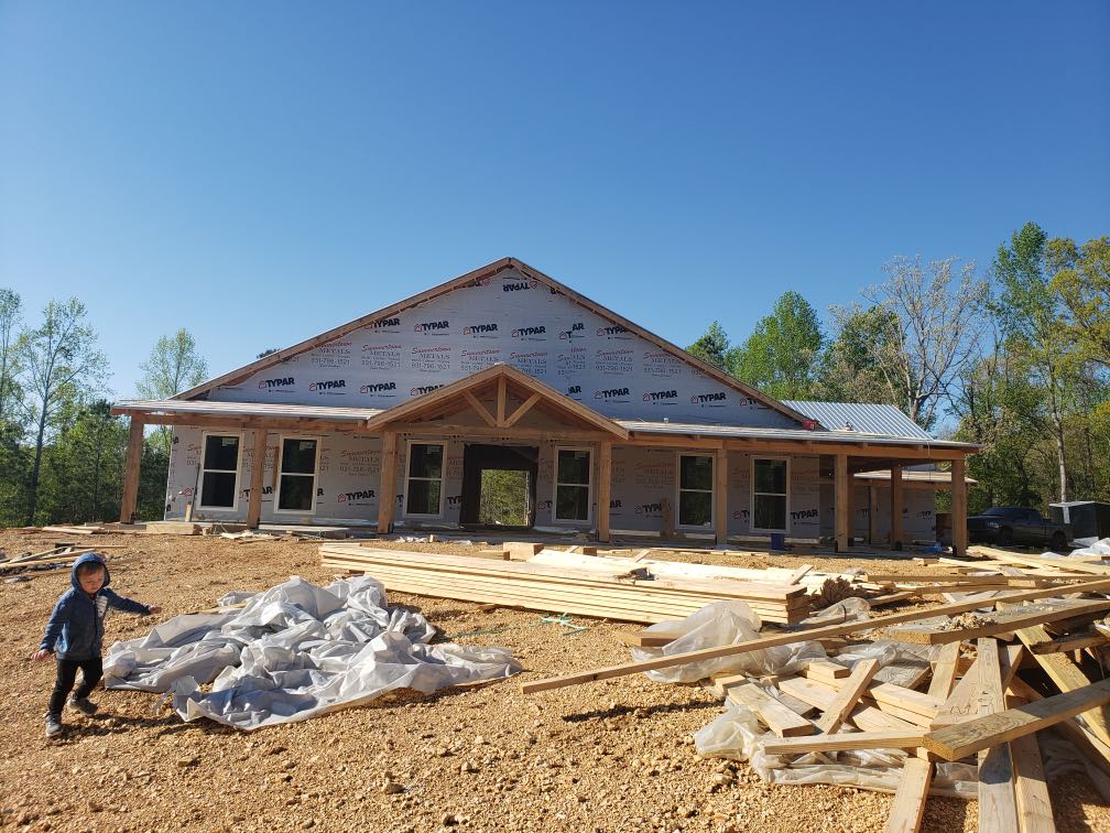 The construction phase of Brandon's Adorable Gray Country Barndominium.