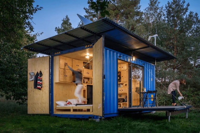 a shipping container home with a hinged roof