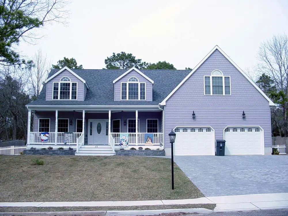 A two-story, light blue modular home by willoughby homes