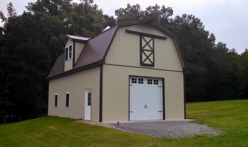 An image showcases a light brown agricultural barndominium with a classic white door at the center. Surrounding the door are small windows that allow natural light to shine in. The barndominium sits under a warm brown roof, blending seamlessly into its rural surroundings.