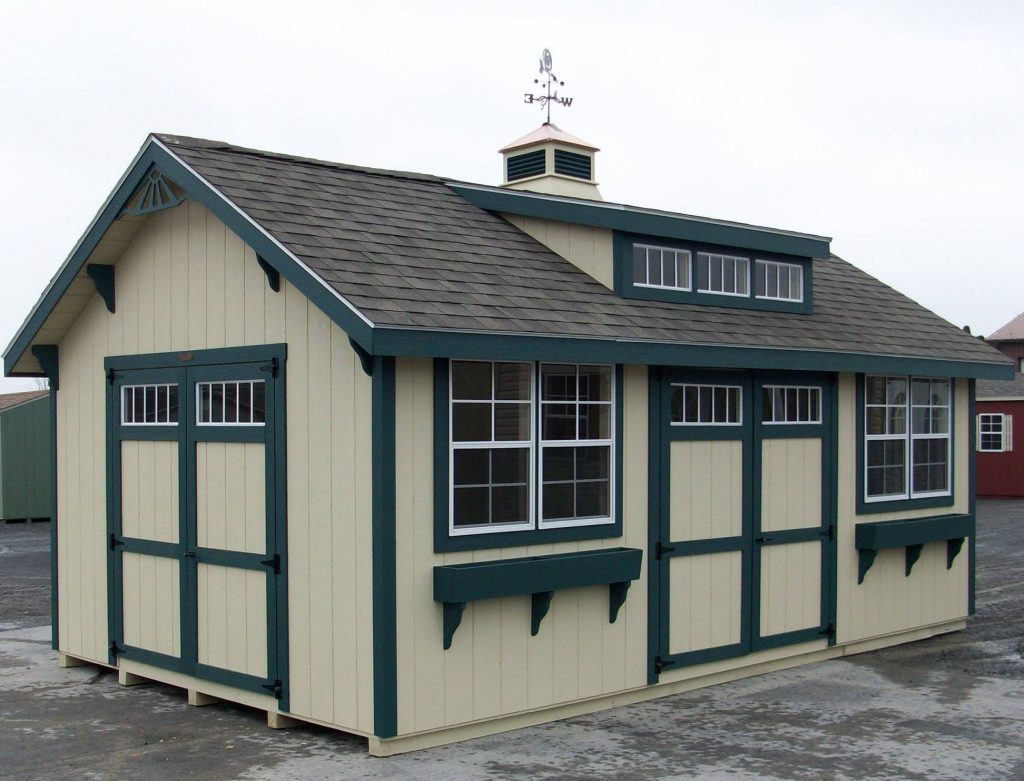 a peach metal barn with small glass window and black roof
