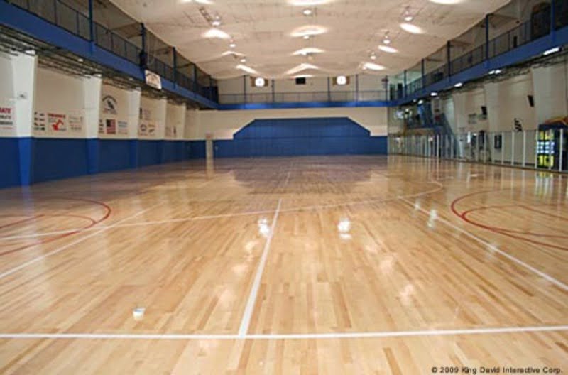 A spacious indoor basketball court is the main attraction in this recreational metal building. The high ceilings and bright lighting create an inviting atmosphere for players and spectators alike. The building's overall design and style make it the perfect place for a pick-up game or a recreational league.