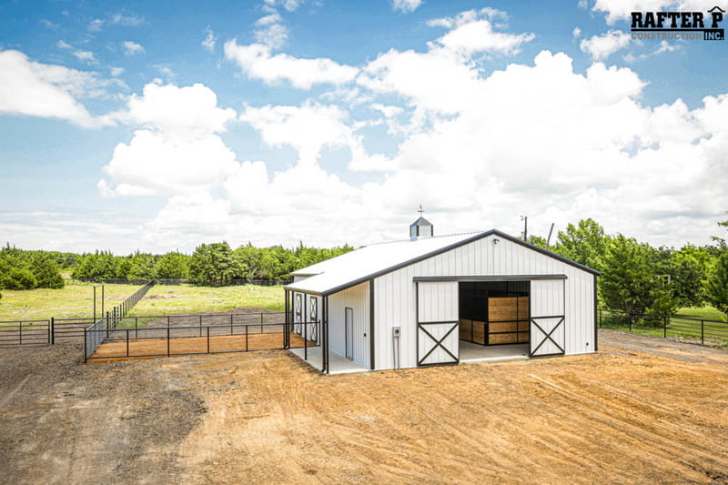 A white storage metal building. The building offers a functional solution with its design combining the features of a barn and a storage facility to create a versatile structure